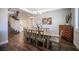 Inviting dining room with wood floors, staircase, and large dining table for the Gathering at 11112 Pine Greens Ct, Las Vegas, NV 89144