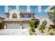 Inviting two-story home featuring a tile roof, a two-car garage, and desert landscaping at 11112 Pine Greens Ct, Las Vegas, NV 89144