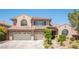 Inviting two-story home featuring a tile roof, a two-car garage, and desert landscaping at 11112 Pine Greens Ct, Las Vegas, NV 89144