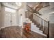 Grand foyer featuring wood floors, a staircase, and a large window at 11112 Pine Greens Ct, Las Vegas, NV 89144