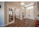 Grand foyer featuring wood floors, a staircase, and a large window at 11112 Pine Greens Ct, Las Vegas, NV 89144
