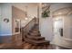 Grand foyer featuring high ceilings, hardwood floors and a staircase with wood banister at 11112 Pine Greens Ct, Las Vegas, NV 89144