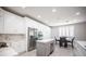 Bright, modern kitchen with stainless steel appliances, island and white cabinets at 11112 Pine Greens Ct, Las Vegas, NV 89144
