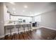 Modern kitchen with white cabinets, stainless steel appliances, and a breakfast bar at 11112 Pine Greens Ct, Las Vegas, NV 89144
