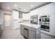 A modern kitchen with white cabinets, a gray island, stainless steel appliances, and sleek countertops at 11112 Pine Greens Ct, Las Vegas, NV 89144