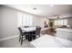 The dining area shows a marble table, black chairs, and an open view into the living room at 11112 Pine Greens Ct, Las Vegas, NV 89144