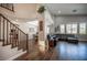Spacious living room with a large leather sectional, high ceilings, and bright, natural lighting at 11112 Pine Greens Ct, Las Vegas, NV 89144