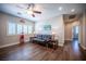 Well-lit living room featuring hardwood floors, a ceiling fan, and comfortable seating at 11112 Pine Greens Ct, Las Vegas, NV 89144