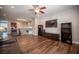 Open-concept living room with hardwood floors, a ceiling fan and comfortable seating, perfect for entertaining at 11112 Pine Greens Ct, Las Vegas, NV 89144