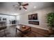 Living area featuring wood floors, ceiling fan, built in fireplace, and access to an adjacent dining area at 11112 Pine Greens Ct, Las Vegas, NV 89144