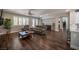 Open-concept living room with wood floors and an arched doorway to the dining room at 11112 Pine Greens Ct, Las Vegas, NV 89144