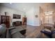 Open-concept living room with vaulted ceilings, natural light, and comfortable leather seating at 11112 Pine Greens Ct, Las Vegas, NV 89144
