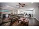 Open-concept living room with wood floors, access to the kitchen and dining room, and modern decor at 11112 Pine Greens Ct, Las Vegas, NV 89144