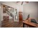 Bright home office featuring a ceiling fan, wood floors, and glass doors at 11112 Pine Greens Ct, Las Vegas, NV 89144