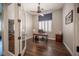 Bright home office featuring a ceiling fan, wood floors, and glass doors at 11112 Pine Greens Ct, Las Vegas, NV 89144