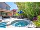 View of backyard patio with BBQ, outdoor seating area, patio and attached spa at 11112 Pine Greens Ct, Las Vegas, NV 89144