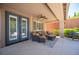 Covered patio features outdoor seating, ceiling fan, and access to backyard at 11112 Pine Greens Ct, Las Vegas, NV 89144