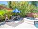 View of the backyard patio space featuring a dining table and seating for six with a built-in spa at 11112 Pine Greens Ct, Las Vegas, NV 89144