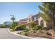 Charming street view featuring well-manicured lawns and appealing two-story homes, with mountain backdrop at 11112 Pine Greens Ct, Las Vegas, NV 89144