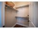 Walk-in closet with white shelving and rack, and wood floors, provides ample storage space at 11112 Pine Greens Ct, Las Vegas, NV 89144