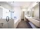Spa-like bathroom with a soaking tub, dual sinks, and a glass-enclosed shower at 11119 River Hills Ln, Las Vegas, NV 89135