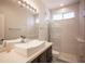 Modern bathroom features a vessel sink, marble countertops, and a glass-enclosed shower at 11119 River Hills Ln, Las Vegas, NV 89135