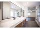 Bright bathroom featuring a double vanity, modern fixtures, and a glass-enclosed shower at 11119 River Hills Ln, Las Vegas, NV 89135