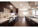 Beautiful kitchen featuring stone backsplash, stainless steel appliances, and dark wood cabinets at 11119 River Hills Ln, Las Vegas, NV 89135
