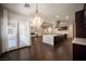 Open-concept living room featuring hardwood floors, stylish chandelier, and outdoor access at 11119 River Hills Ln, Las Vegas, NV 89135