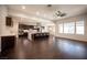 Spacious living room open to modern kitchen featuring dark hardwood floors and lots of natural light at 11119 River Hills Ln, Las Vegas, NV 89135