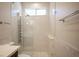 Luxurious shower featuring a multi-head system, sleek glass enclosure and marble tile at 11119 River Hills Ln, Las Vegas, NV 89135