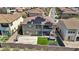 Aerial view of a private backyard with a hot tub, lush greenery, solar panels, and a basketball court at 12155 Sage Thunder Ave, Las Vegas, NV 89138
