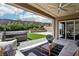 This backyard features a hot tub, artificial grass, and stylish outdoor seating, perfect for outdoor living and entertaining at 12155 Sage Thunder Ave, Las Vegas, NV 89138