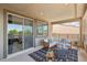 Relaxing covered balcony with a stylish rug, comfortable seating, and sliding glass doors creating a serene outdoor retreat at 12155 Sage Thunder Ave, Las Vegas, NV 89138