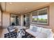 Balcony with comfortable seating, modern decor, and sliding glass doors offers a relaxing space with views of the surroundings at 12155 Sage Thunder Ave, Las Vegas, NV 89138