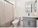 Clean bathroom with a modern vanity, square mirror, stylish lighting, and a shower with bright white curtain at 12155 Sage Thunder Ave, Las Vegas, NV 89138