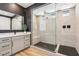 Modern bathroom featuring a glass-enclosed shower with black hardware and neutral tiling, and white countertop at 12155 Sage Thunder Ave, Las Vegas, NV 89138