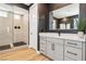 Stylish bathroom with a glass shower featuring sleek black fixtures, and a modern vanity with black hardware at 12155 Sage Thunder Ave, Las Vegas, NV 89138