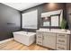 Modern bathroom featuring a soaking tub, stylish vanity, and bright natural light at 12155 Sage Thunder Ave, Las Vegas, NV 89138