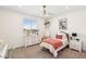 Bright bedroom featuring a large window, white dresser, and a comfortable single bed at 12155 Sage Thunder Ave, Las Vegas, NV 89138