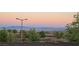 Stunning city view from behind a neighborhood wall, showcasing mountains in the distance and desert landscaping at 12155 Sage Thunder Ave, Las Vegas, NV 89138