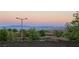 Breathtaking city view from behind a neighborhood wall, showcasing mountains in the distance and desert landscaping at 12155 Sage Thunder Ave, Las Vegas, NV 89138