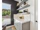 Dining area featuring a marble countertop, floating shelves, drawers, and a view of the backyard at 12155 Sage Thunder Ave, Las Vegas, NV 89138