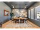 Dining room featuring an oversized table, modern light fixtures, and two large windows at 12155 Sage Thunder Ave, Las Vegas, NV 89138