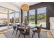 Bright dining room featuring a modern light fixture, table, and chairs, with sliding doors to the patio at 12155 Sage Thunder Ave, Las Vegas, NV 89138