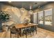 A well-appointed dining area featuring stylish light fixtures, a wooden table, and unique wallpaper for a sophisticated touch at 12155 Sage Thunder Ave, Las Vegas, NV 89138
