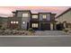 Beautiful modern home with desert landscaping and a two-car garage with brick driveway at 12155 Sage Thunder Ave, Las Vegas, NV 89138