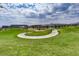 Expansive green space featuring a winding pathway, manicured lawns, and views of the community buildings in the distance at 12155 Sage Thunder Ave, Las Vegas, NV 89138