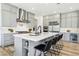 Bright and airy kitchen with stainless steel appliances, an island with seating, and gray cabinets at 12155 Sage Thunder Ave, Las Vegas, NV 89138