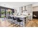 Spacious kitchen with an island, stainless steel appliances, gray cabinetry, and adjacent dining area at 12155 Sage Thunder Ave, Las Vegas, NV 89138
